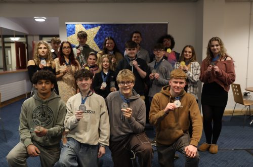 Group of learners holding medals