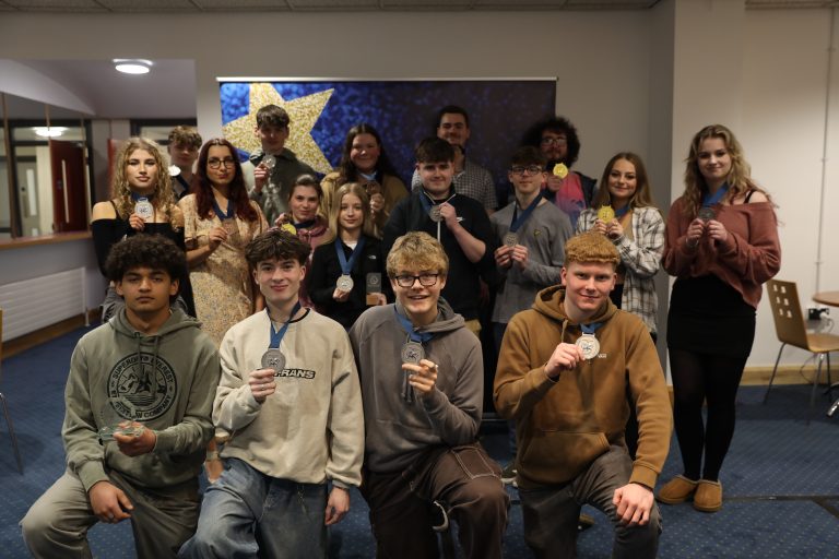 Group of learners holding medals
