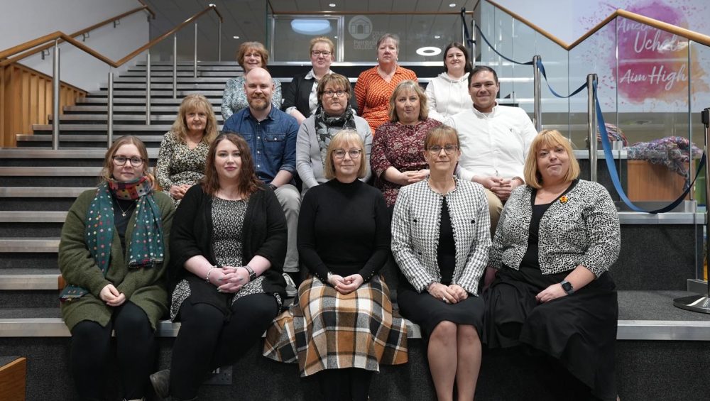 Group of staff sitting on steps.