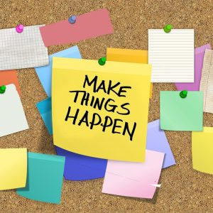 post-it notes and blank pieces of paper pinned to a notice board