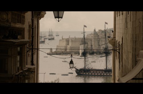Apple Original Film Clip from the Napoleon Movie with a ship of the water and in the foreground beige buildings