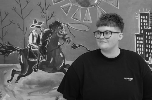 Caitlin with one of her selected artworks from her tour “Going Away in Order To Return”