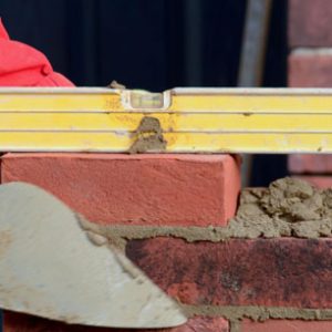 Spirit level on a brick, with trowel
