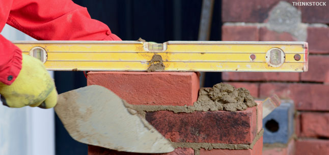Spirit level on a brick, with trowel
