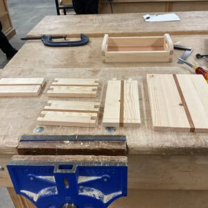WOOD PIECES LAID OUT ON A BENCH FOR CUTTING