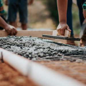 people flattening wet concrete