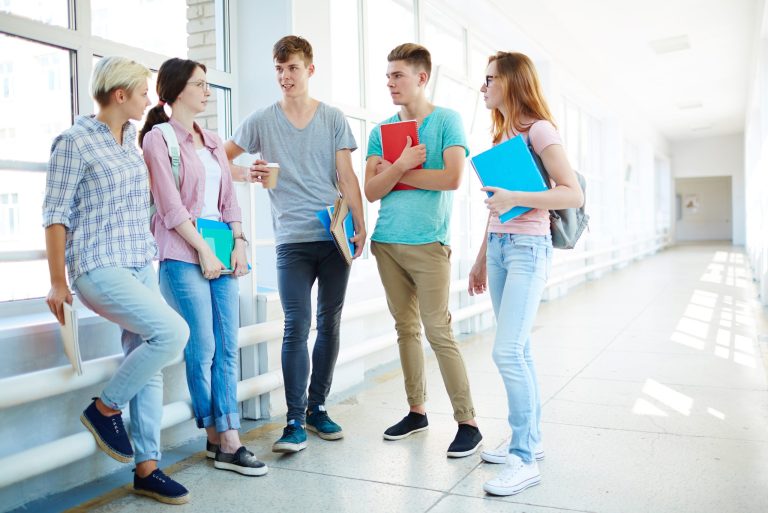 Group of students standing in hall.