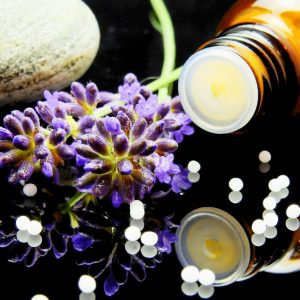 oil bottle on its side with lavendar flower