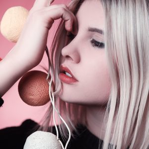 blonde female holing brown string lights