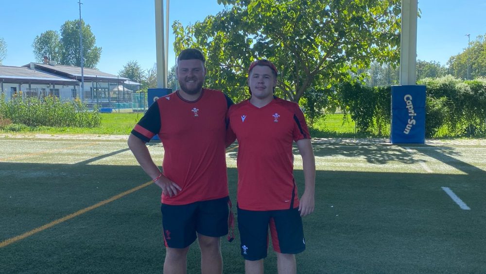 Two people wearing rugby kit