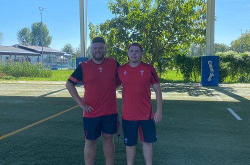 Two people wearing rugby kit