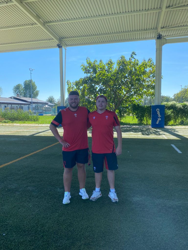 Two people wearing rugby kit