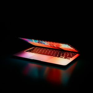 laptop half opened on a black background