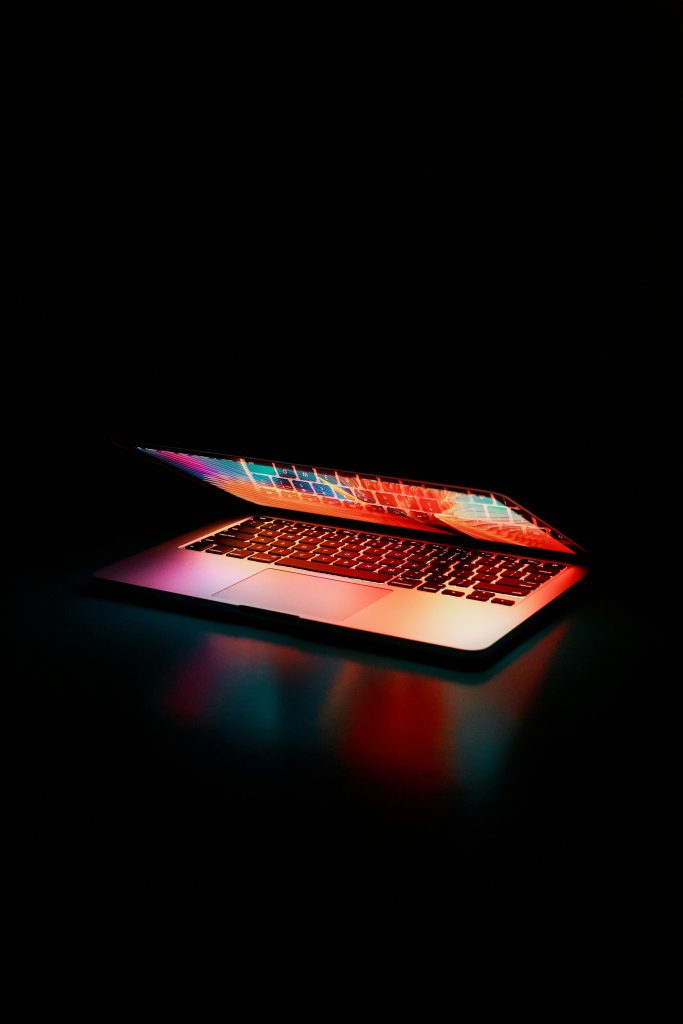 laptop half opened on a black background