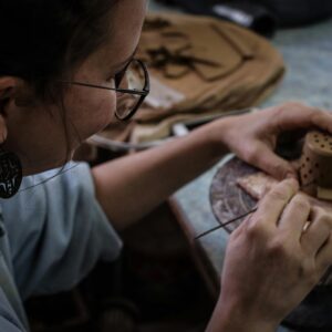 Person hand crafting clay pot