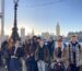 Group of students standing by the Thames with Westminster in background.