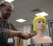 Marcus styling a mannequin head with bright yellow hair