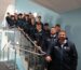 Group of staff and students on the stairs.