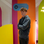 Student standing against a bright background
