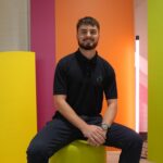 Student sitting against a bright background