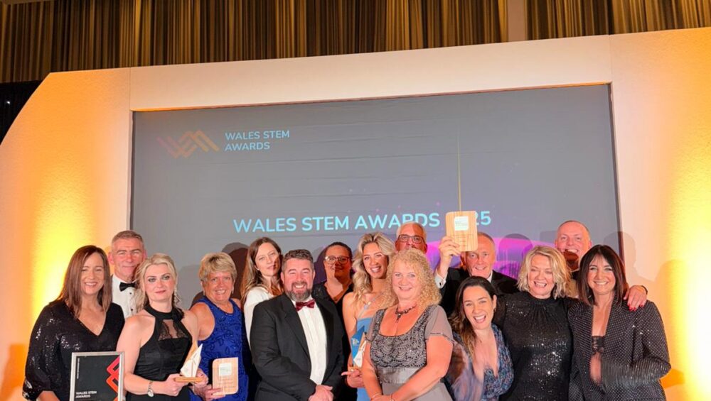 Group of people on stage receiving award