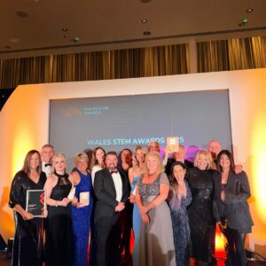 Group of people on stage receiving award