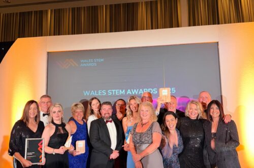 Group of people on stage receiving award