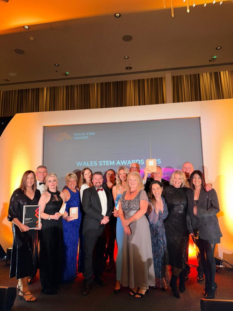 Group of people on stage receiving award