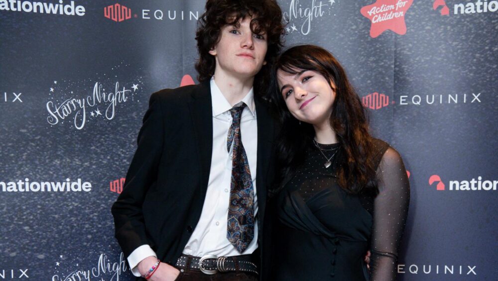 Two students against gala backdrop