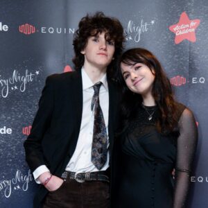 Two students against gala backdrop