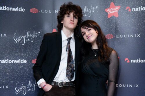 Two students against gala backdrop