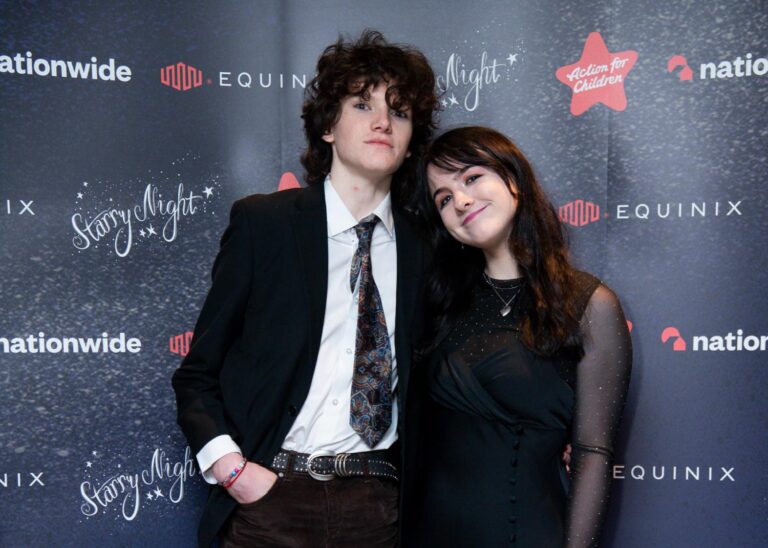Two students against gala backdrop