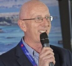 Photo of Andrew holding a microphone