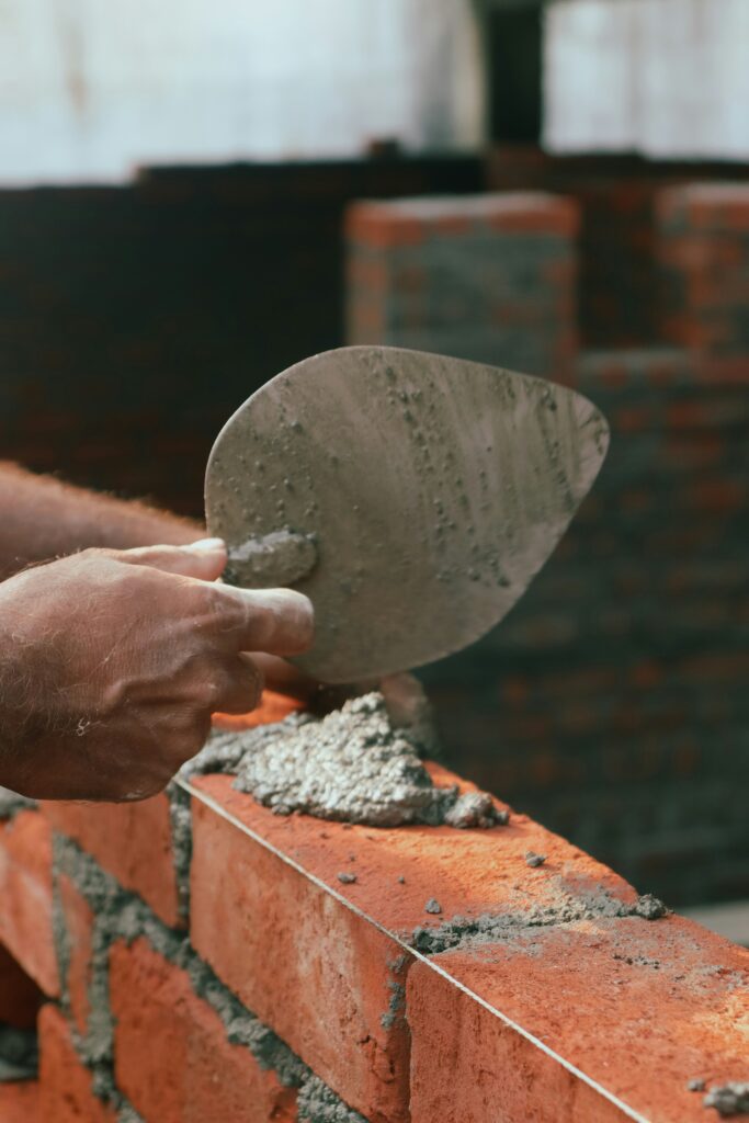 trowel held above a newly built wall