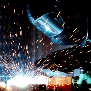 Welder at work with tools and mask.