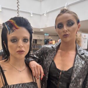 Two people with unique hairstyles and rock chic look.