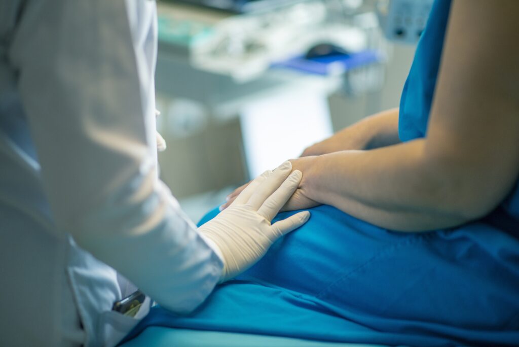 medical gloved hand providing supprt