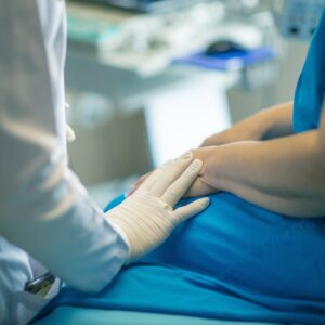 medical gloved hand providing supprt